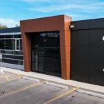 Wide shot of a modern commercial building with brown and black panels.