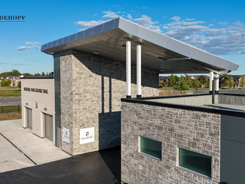 Aerial view of a modern building with a large canopy and gray ACM cladding, part of a Gray ACM Commercial Project.