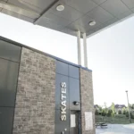 Entrance to skates rental with gray ACM panels and stone facade, part of a Gray ACM Commercial Project.