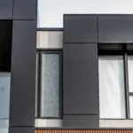 A detailed shot of modern exterior materials, including ACM panels, WPC siding, and windows.