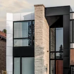 Front entrance of a modern North York house, showcasing ACM, WPC, and stone finishes.