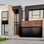 Modern residential facade with North York ACM and WPC paneling, stone accents, and a black garage door.
