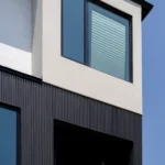 Close-up of a modern home's exterior featuring Toronto PVC & WPC Shadow Gap siding.