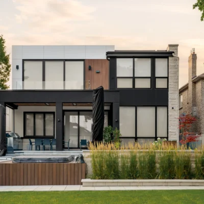 A modern residential building facade with a mix of horizontal and vertical siding panels.