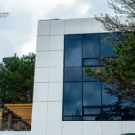 White ACM building with reflective windows and pergola in North York, Ontario
