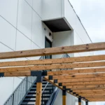 White ACM building with staircase and wooden pergola in North York, Ontario